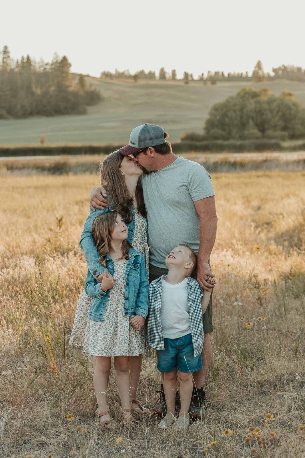 family-in-coordinating-outfits-posing-outdoors-during-a-mini-session-in-spokane