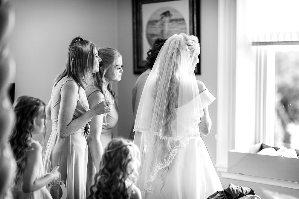 Bride and Bridesmaids looking out of window at Shottle Hall Derbyshire