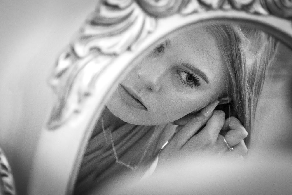Bridesmaid reflection in mirrow at Shottal Hall Derbyshire
