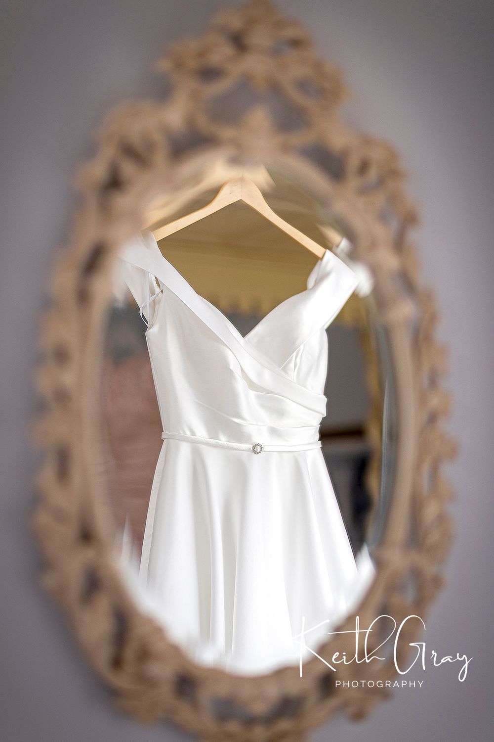 Wedding dress reflected in mirror at Shottle Hall Derbyshire