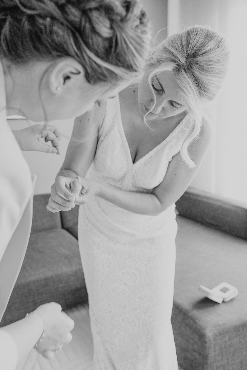 Close-up series of a bride in a white dress preparing for her wedding day.