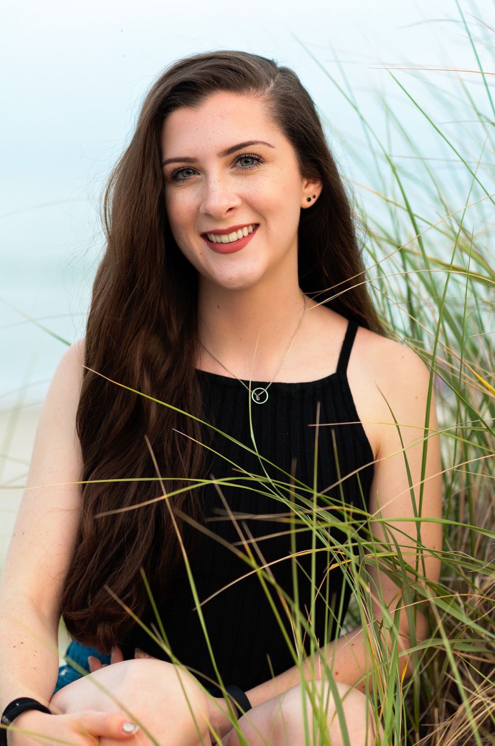 A teenage portrait of a teen girl in the ocean dune grasses