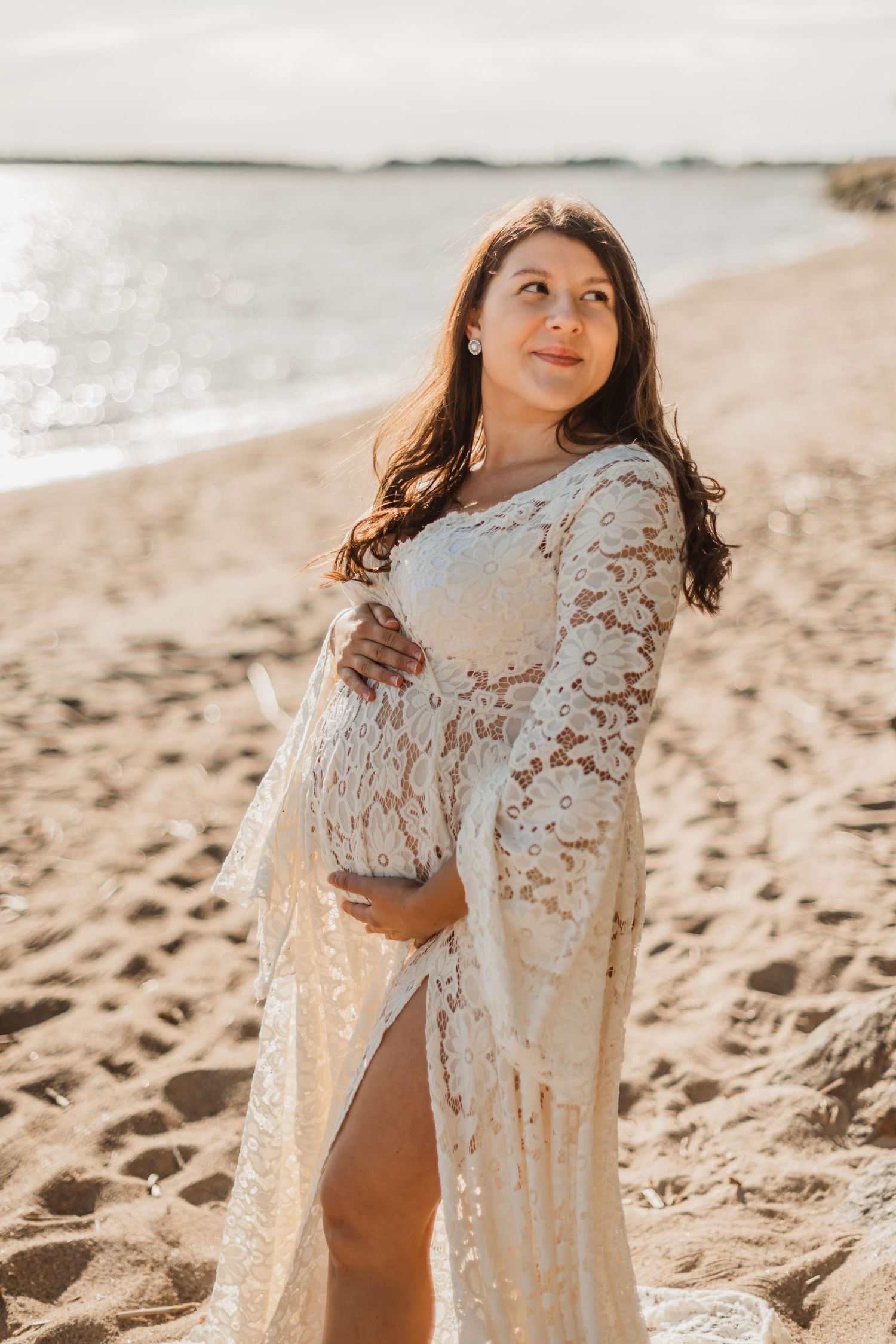 Expecting couple shares intimate moment at sunset in outdoor maternity photoshoot.