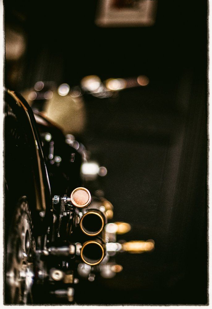 Artistic bokeh photograph of vintage motorcycle gauges and controls.