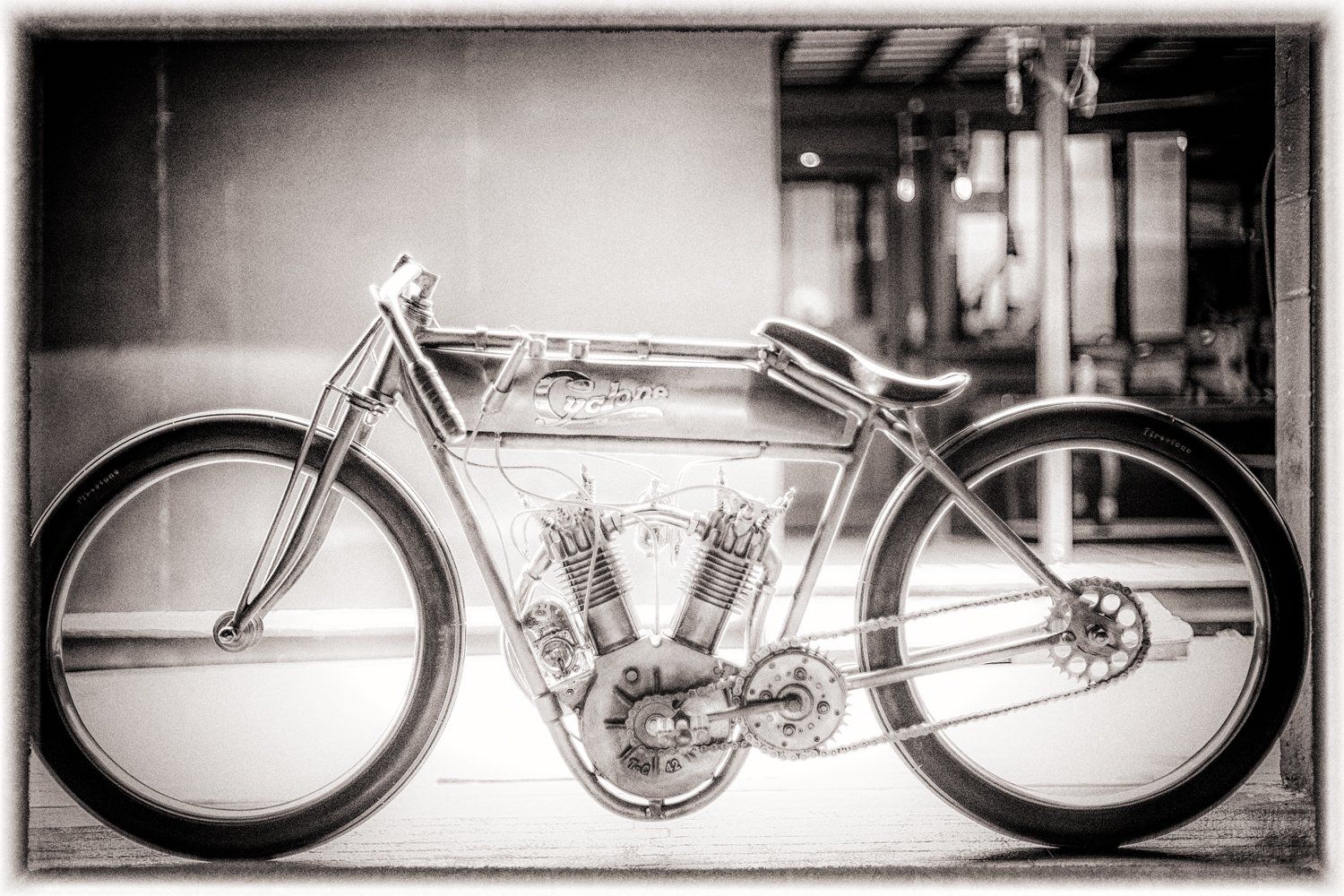 Antique motorcycle in black and white showing classic engineering and design.