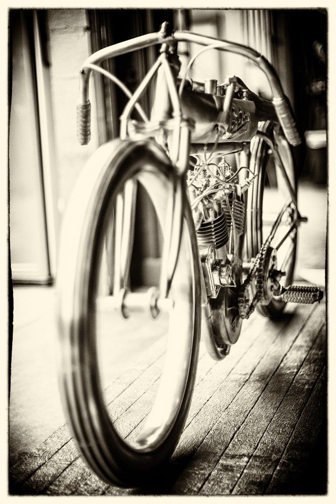 Artistic black and white close-up of a vintage bicycle wheel and frame.