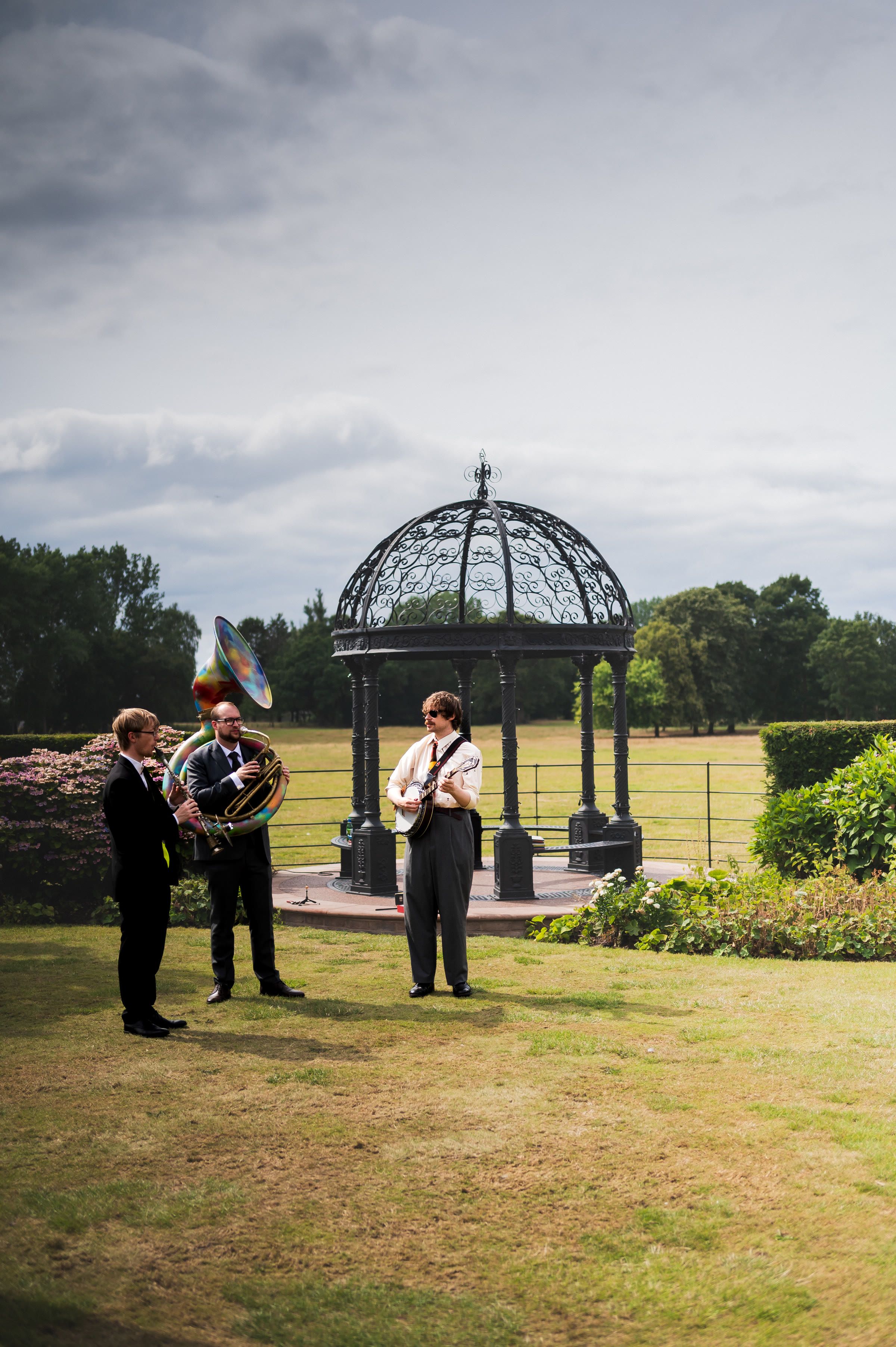 Musicians by the gazebo in the grounds, Merrydale Manor wedding photography in Cheshire