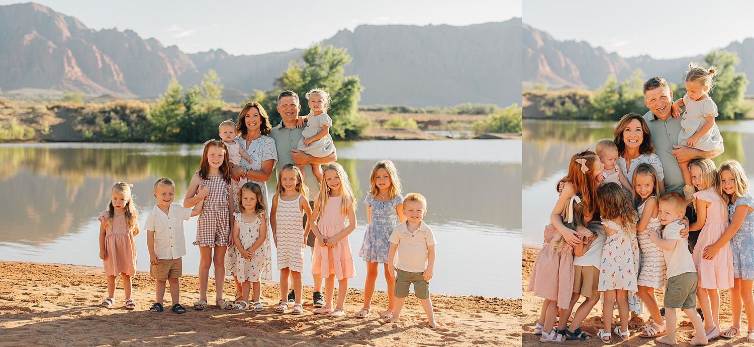 Large family group portrait outdoors near a lake with red rock mountains, children and adults in neutral tones.