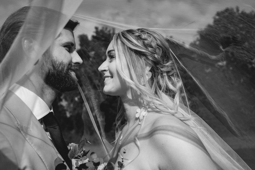 Black and white photo collage showing joyful wedding moments with dancing and laughter at an outdoor celebration.