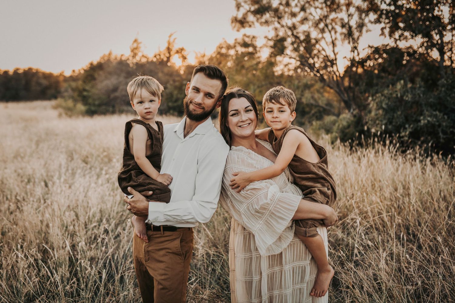 Little boy hugging his pregnant mom during an outdoor family maternity session