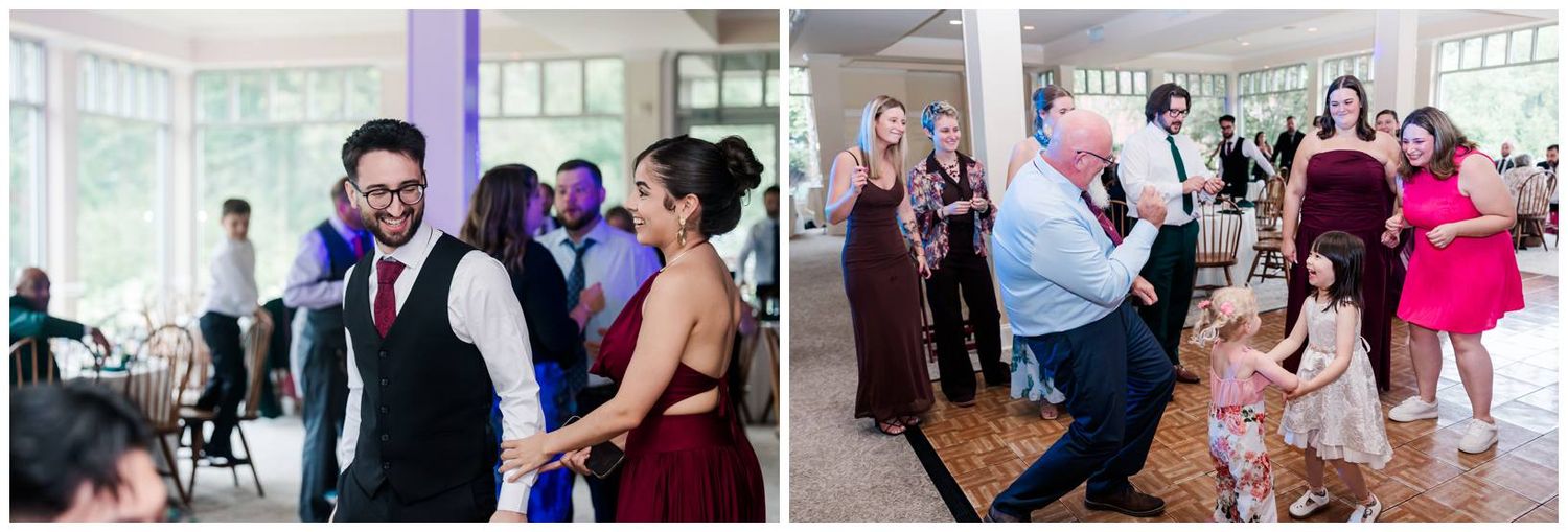 Guests dancing and celebrating joyfully at an elegant wedding reception with large windows and warm lighting.