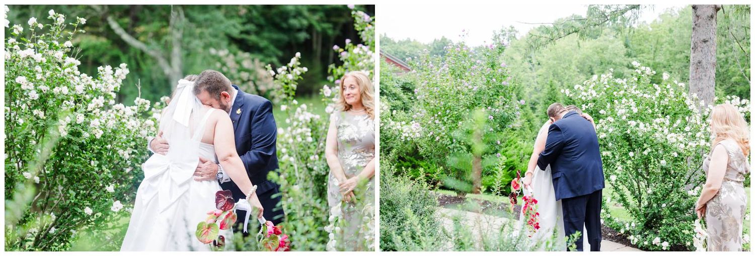 Bride and groom share a tender moment in a lush garden during their outdoor wedding ceremony.