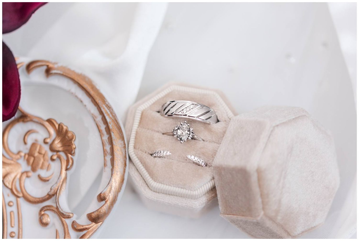 Elegant wedding ring set displayed in a velvet octagonal ring box with diamond engagement and band rings.