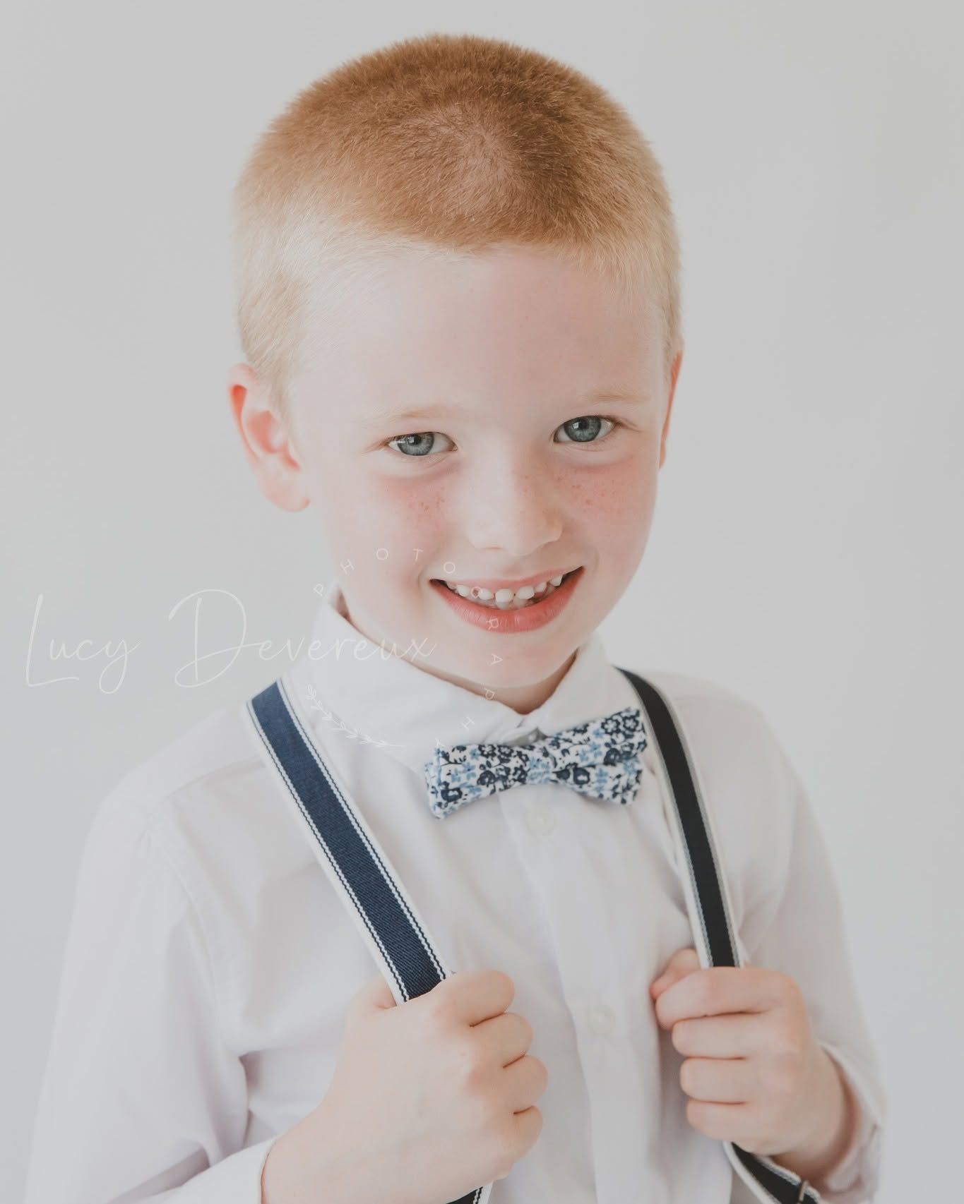 Family photo session. Portrait, red hair, boy and braces, blue eyes.