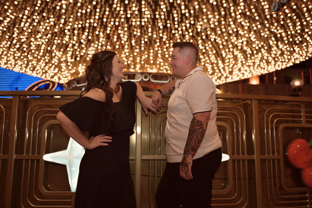 Couple sharing a romantic moment under sparkling lights in an elegantly decorated venue.