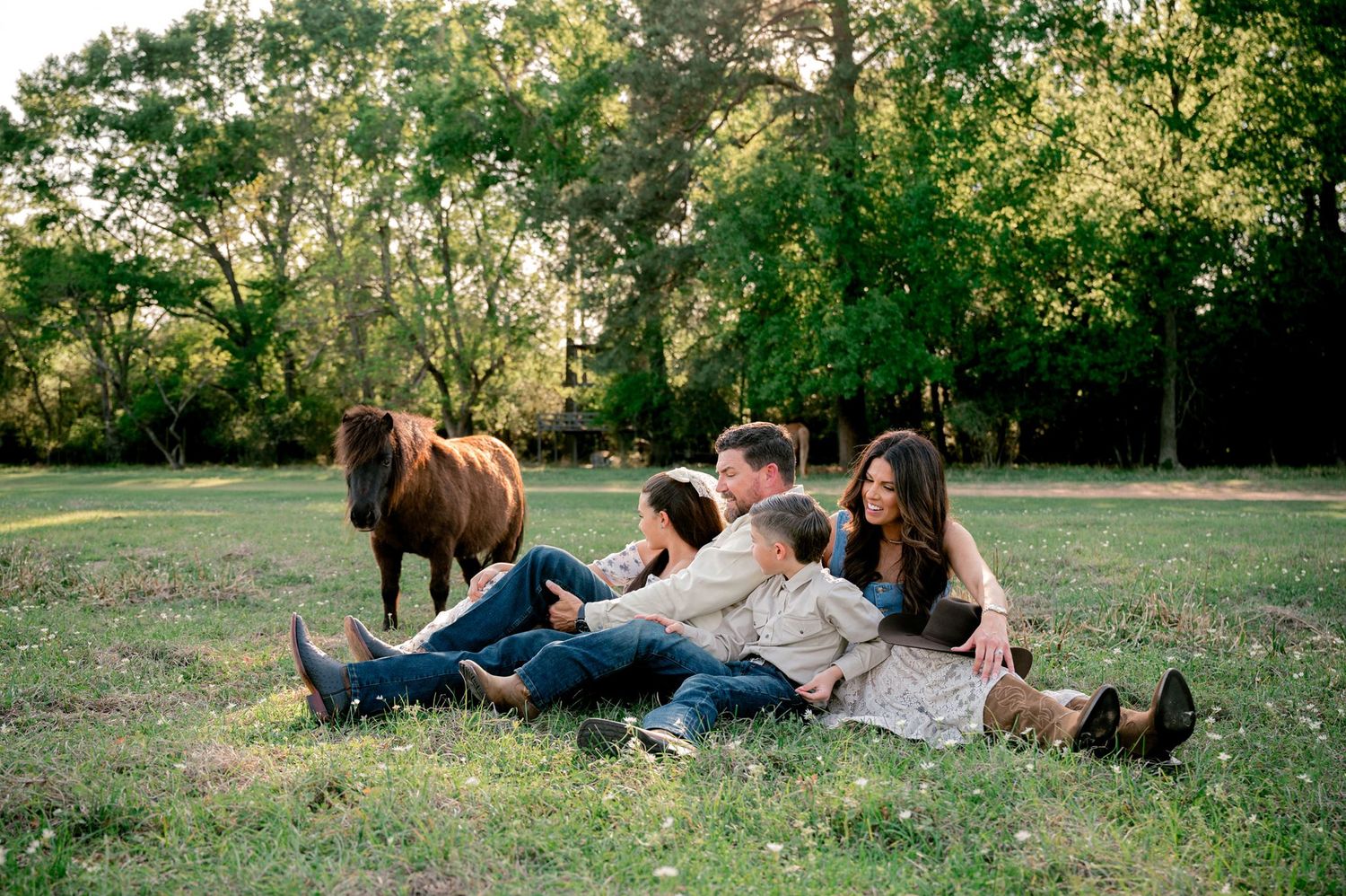 Curious rescue donkeys joining a family's candid photography session at Good Vibes Farm.