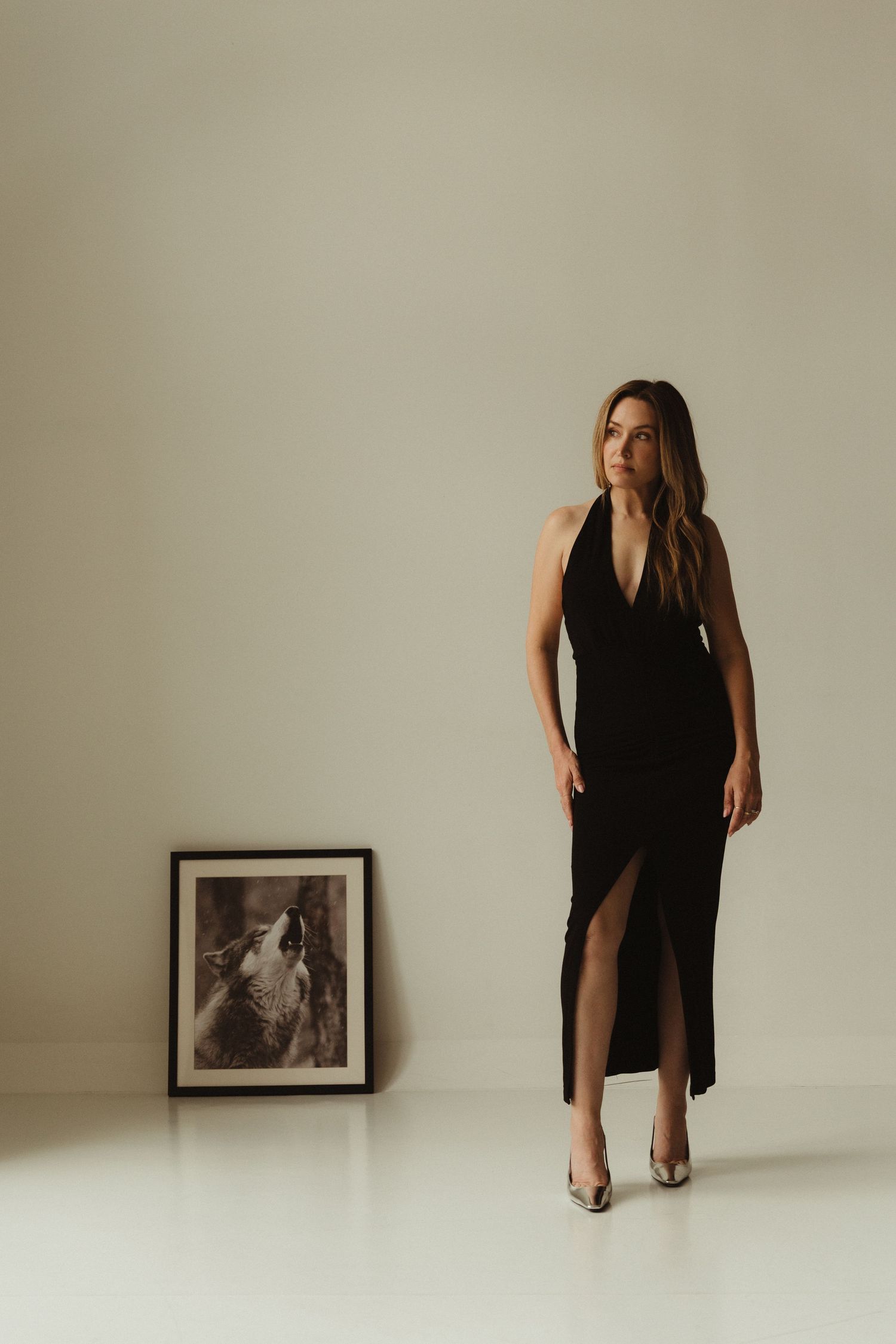 Serenbe personal stylist Jessica Maney stands in elegant black dress with wolf picture behind her, Atlanta editorial portrait photographer