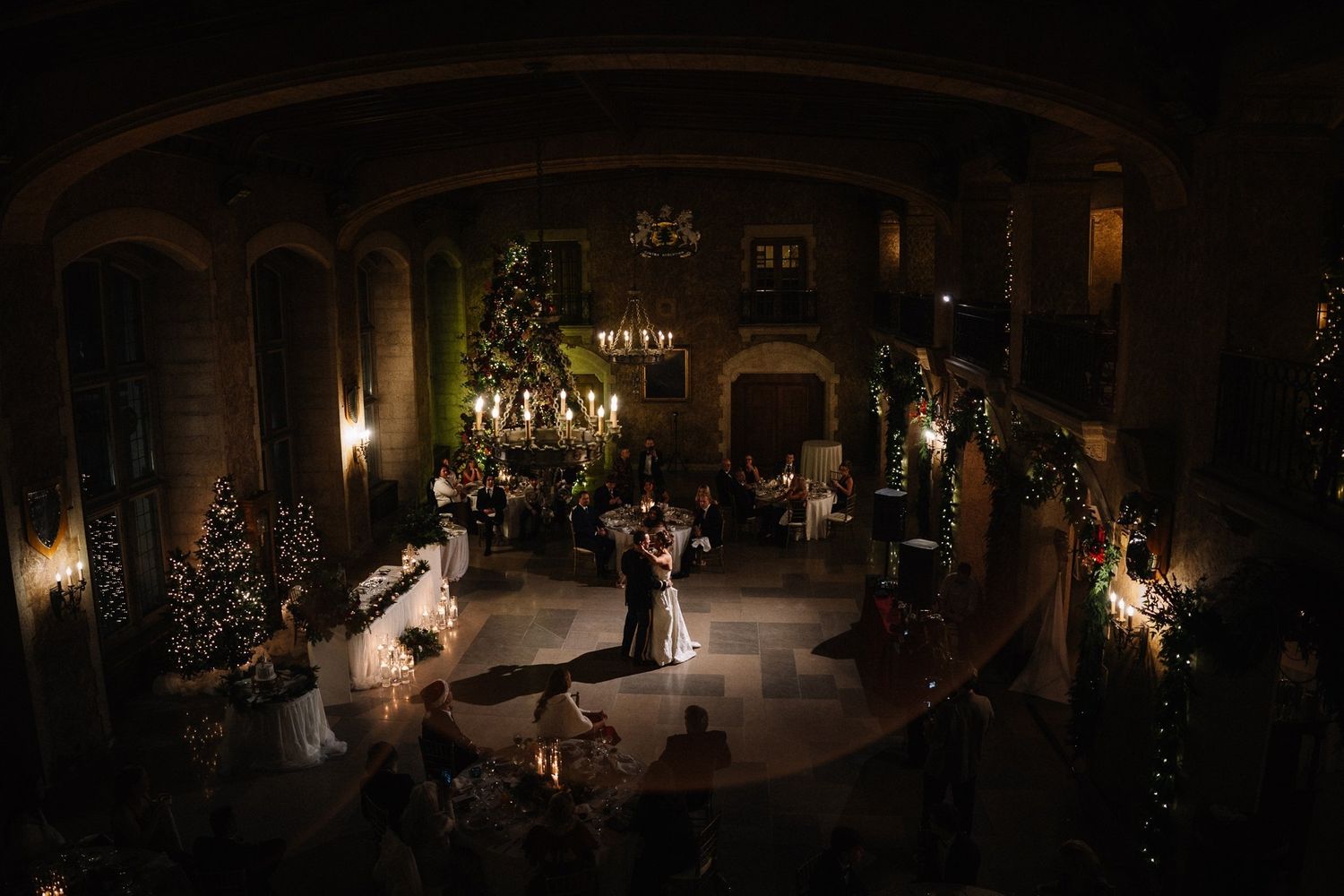 Romantic first dance in a grand candlelit reception hall, by a Calgary wedding photographer