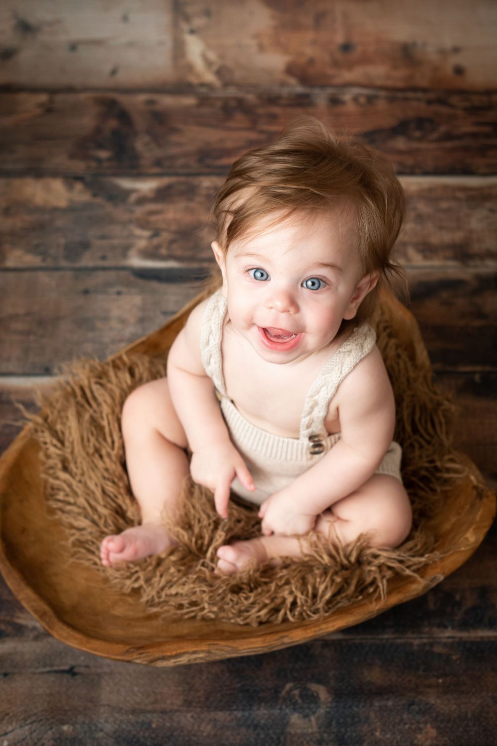 Smiling baby photographed during a milestone session in Central Louisiana.