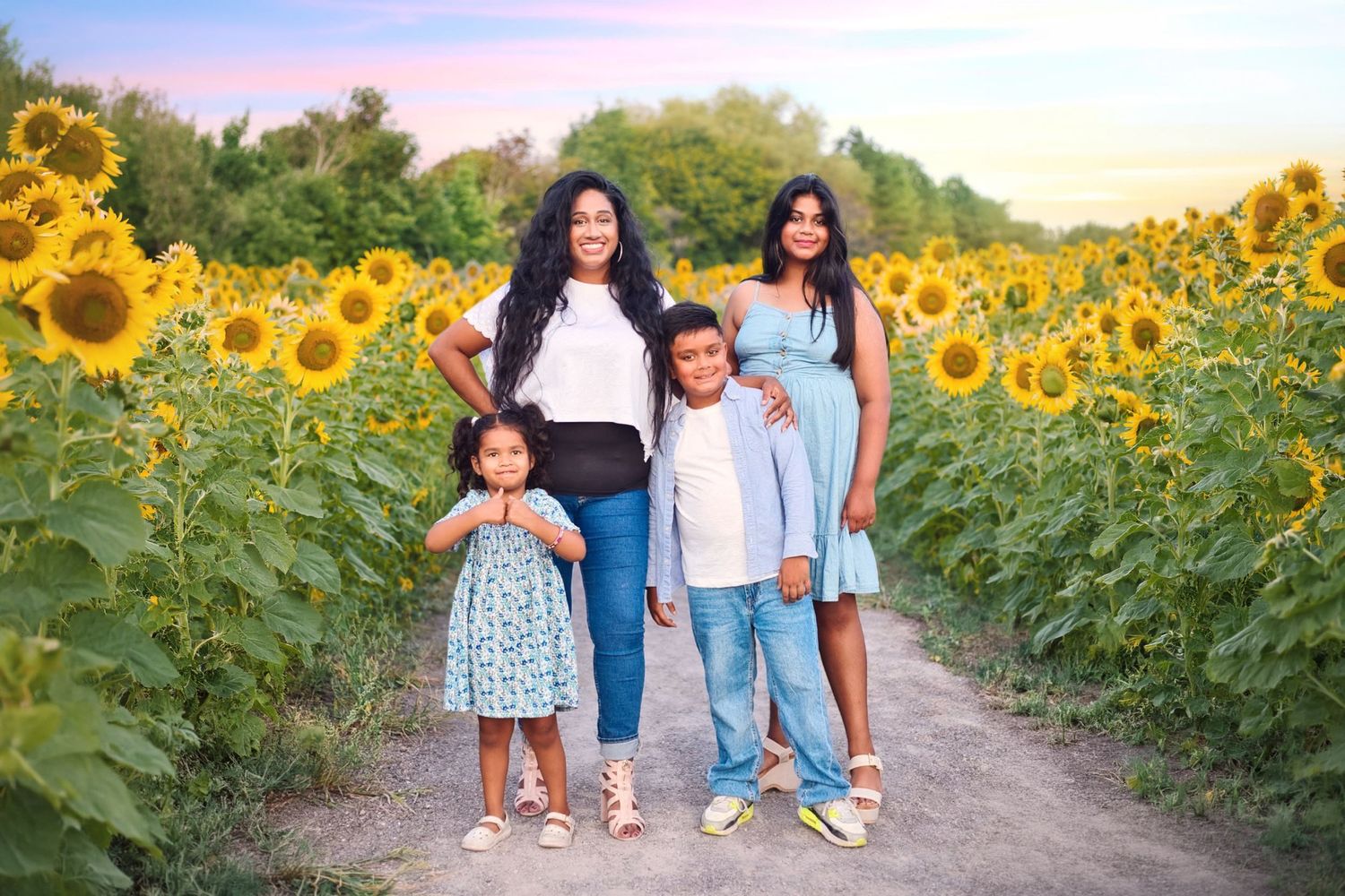 Extended family posing together in a beautiful outdoor location with fall foliage. Toronto family photography.