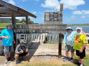 Group of four anglers pose with a large stringer of fish at San Patricio Navigation District.
