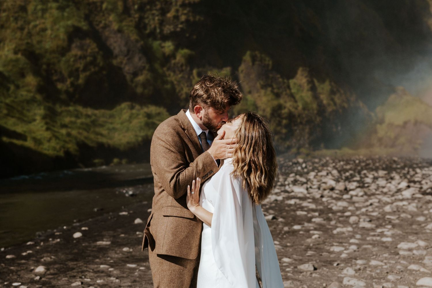 eloping couple kissing at Skógafoss during their Iceland elopement day