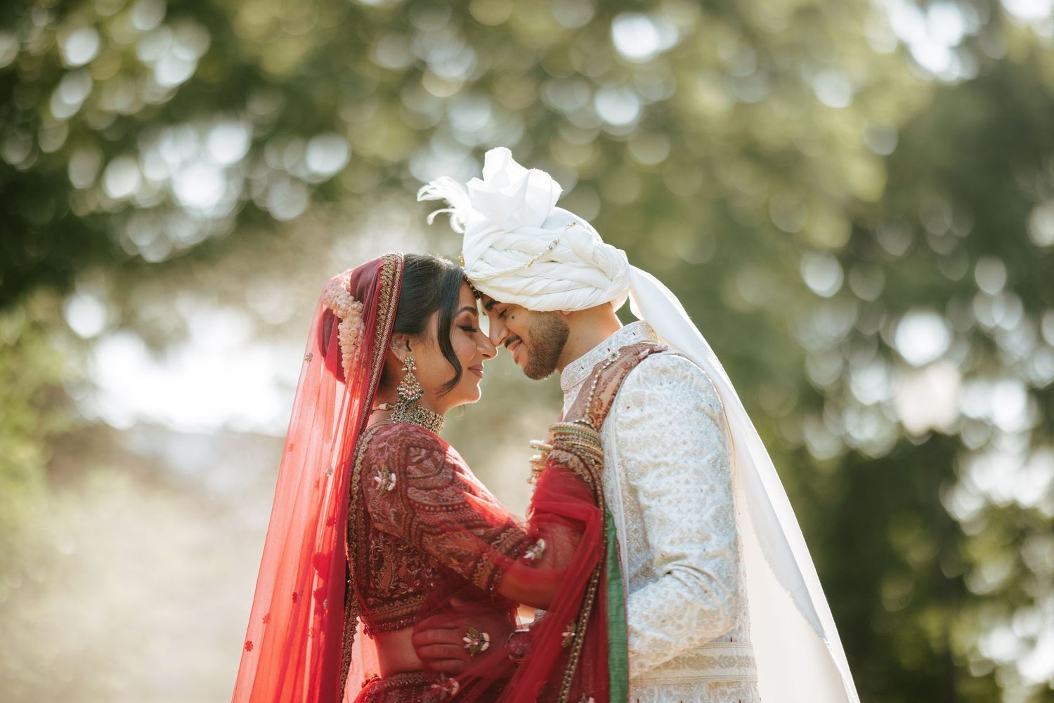 Romantic wedding portrait at Bridgewater Marriott with South Asian couple in traditional attire sharing an intimate moment under soft light.