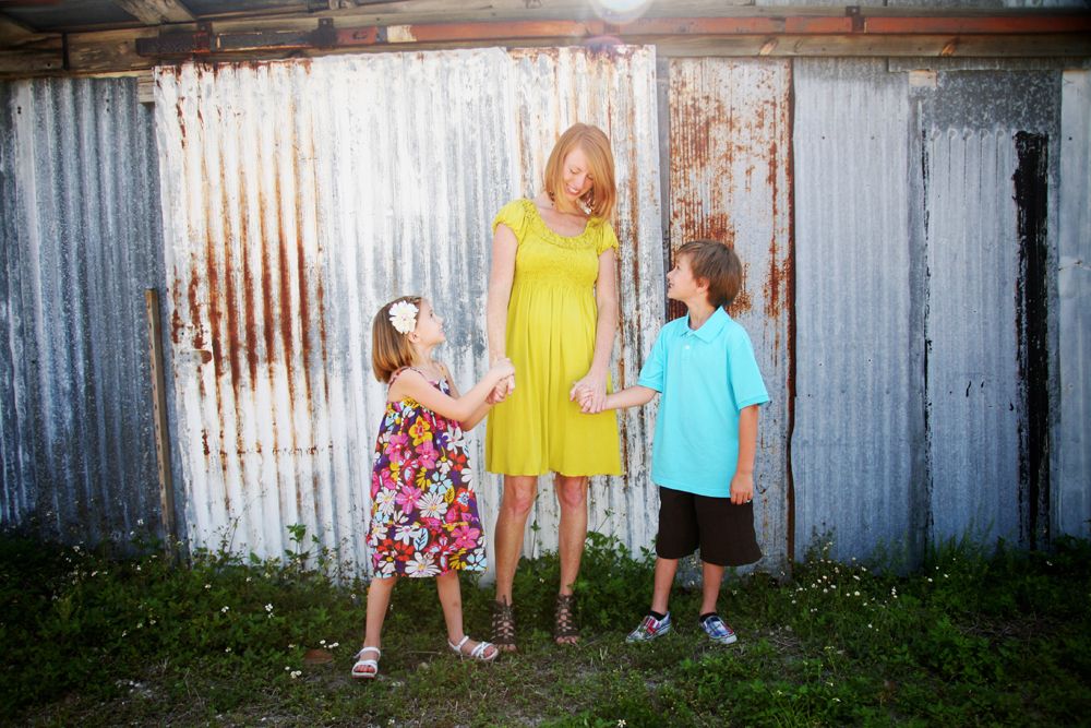 Mom walking hand in hand with her two children
