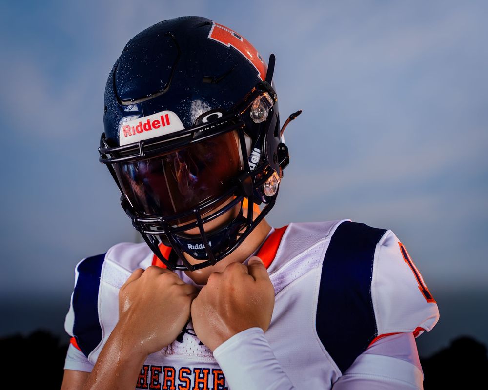 Hershey Trojans football player, hands clasped, visor down, Media Day portrait, by Deanna Fox, SportsFox Photography based in Hershey P
