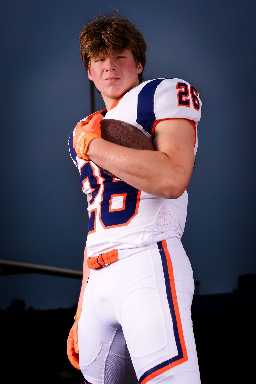 Hershey Trojans football player, #26, holding the football, Media Day portrait, by Deanna Fox, SportsFox Photography based in Hershey PA