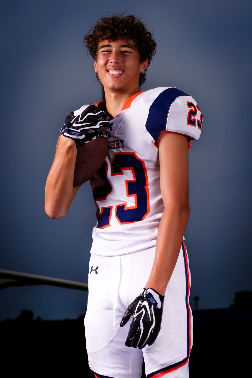 Hershey Trojans football player, #23, holding his helmet, Media Day portrait, by Deanna Fox, SportsFox Photography based in Hershey PA
