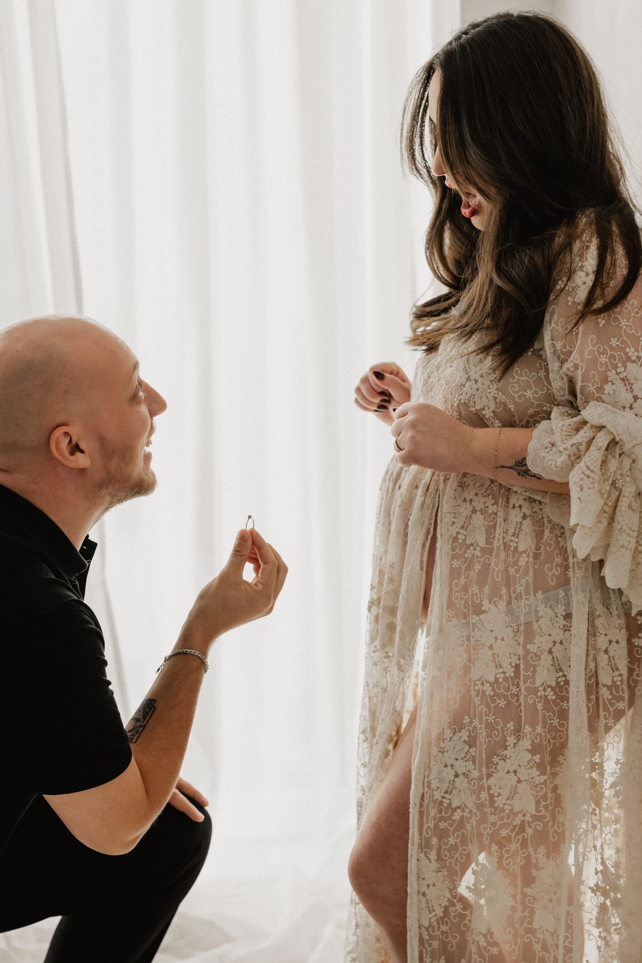 Parents lovingly gaze at their newborn baby, sharing a tender family moment in warm, soft lighting.