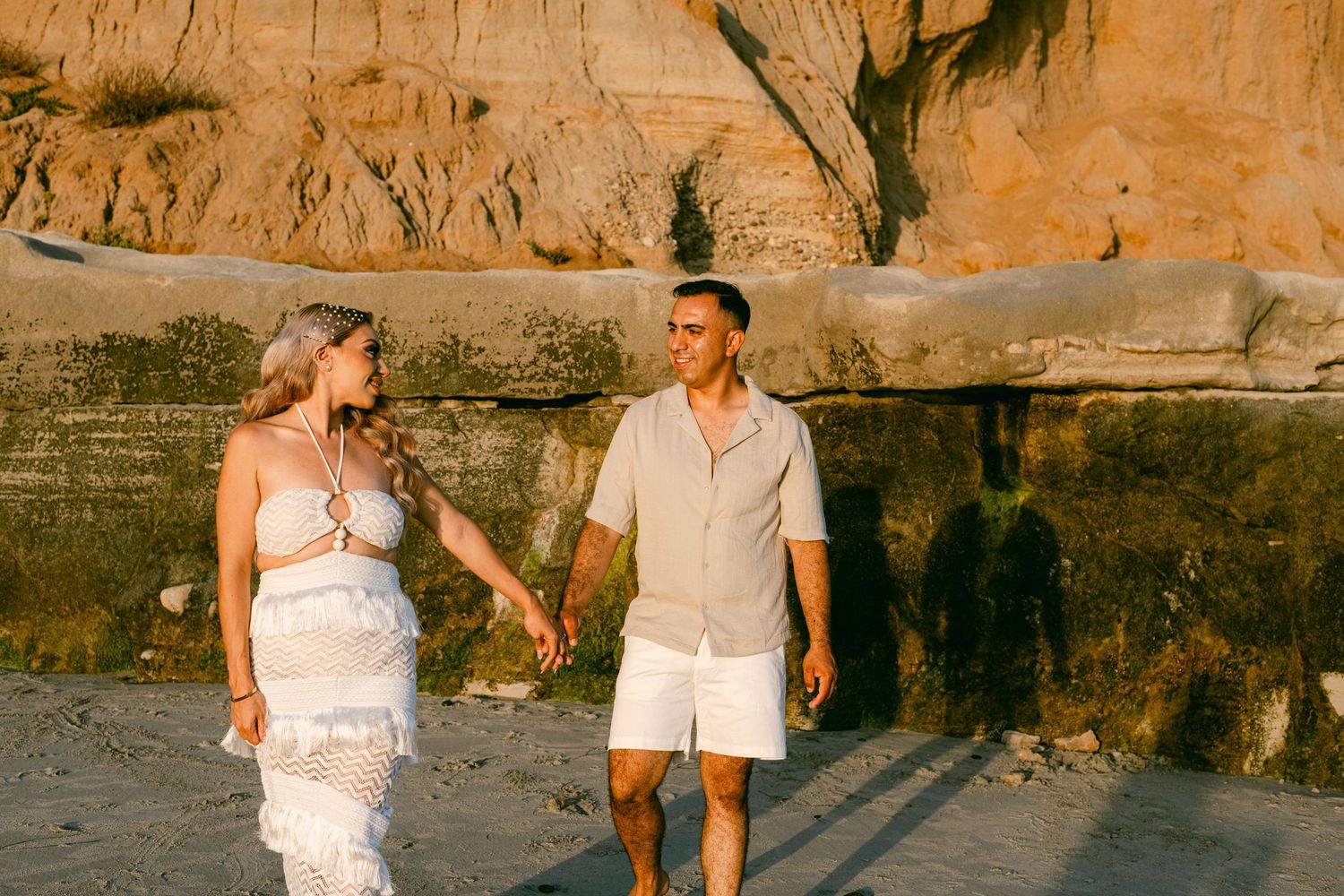 Couples photo session on Carlsbad California beach during sunset.
