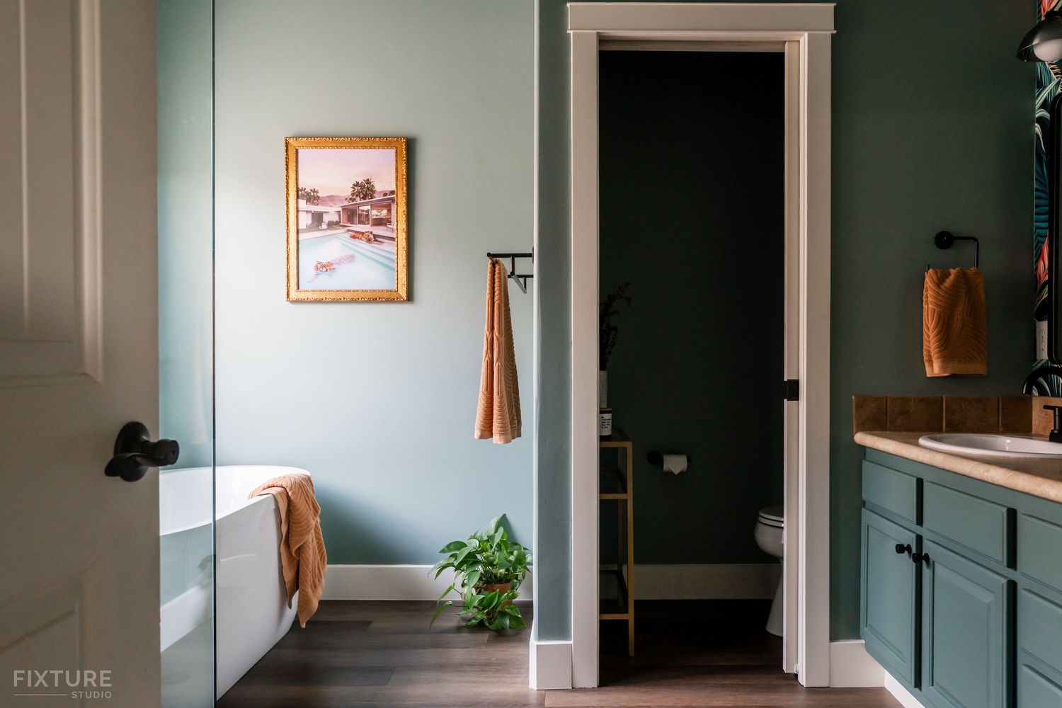 bathroom with tub and artwork