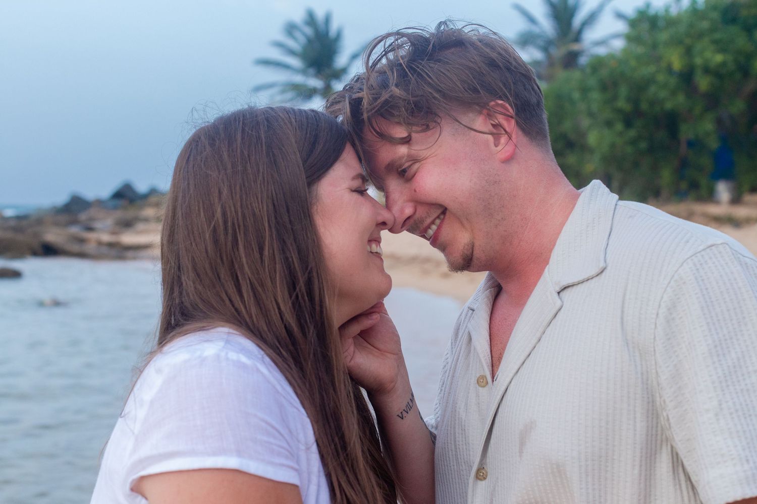 Couples portrait on the beach at Balneario del Escambrón in Old San Juan, Puerto Rico.