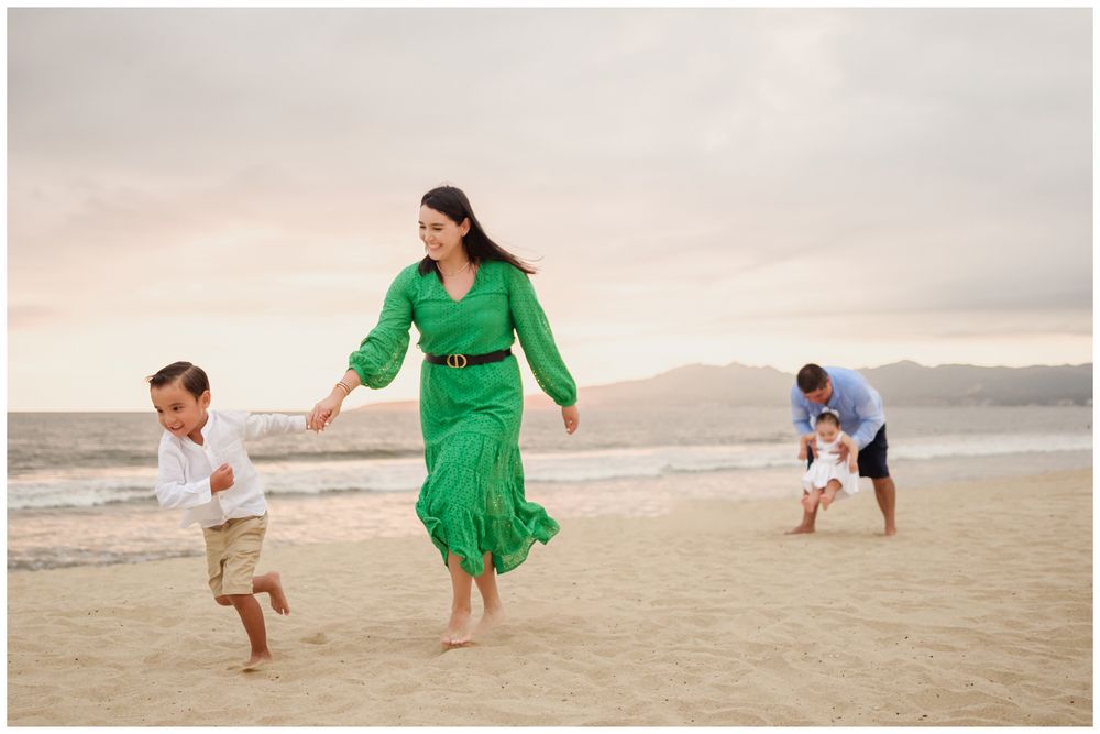 Family enjoying a Punta Mita beach day by the ocean, candid family photography with parents and children in Riviera Nayarit.