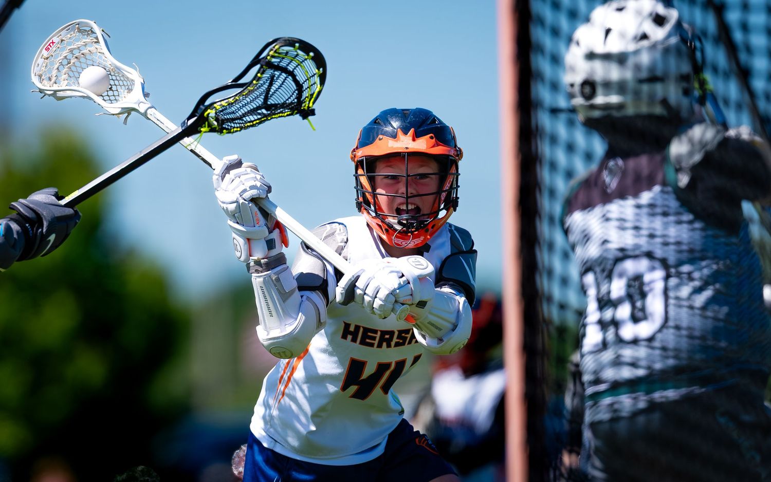 Hershey youth lacrosse player cradling near the goal at the Mid Penn Tournament, by Deanna Fox, SportsFox Photography based in Hershey PA