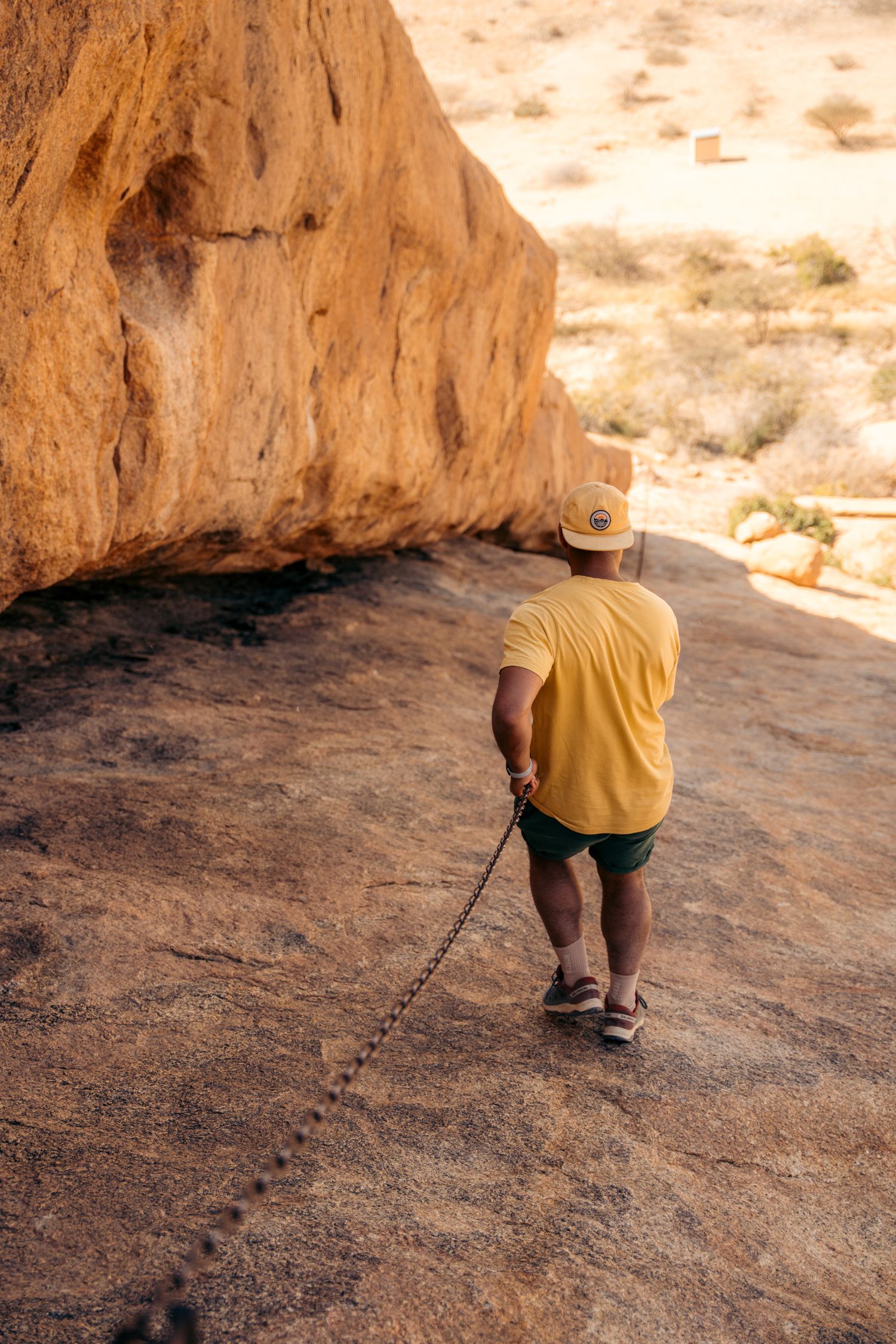 chain walk spitzkoppe, homme qui descend le long du cable