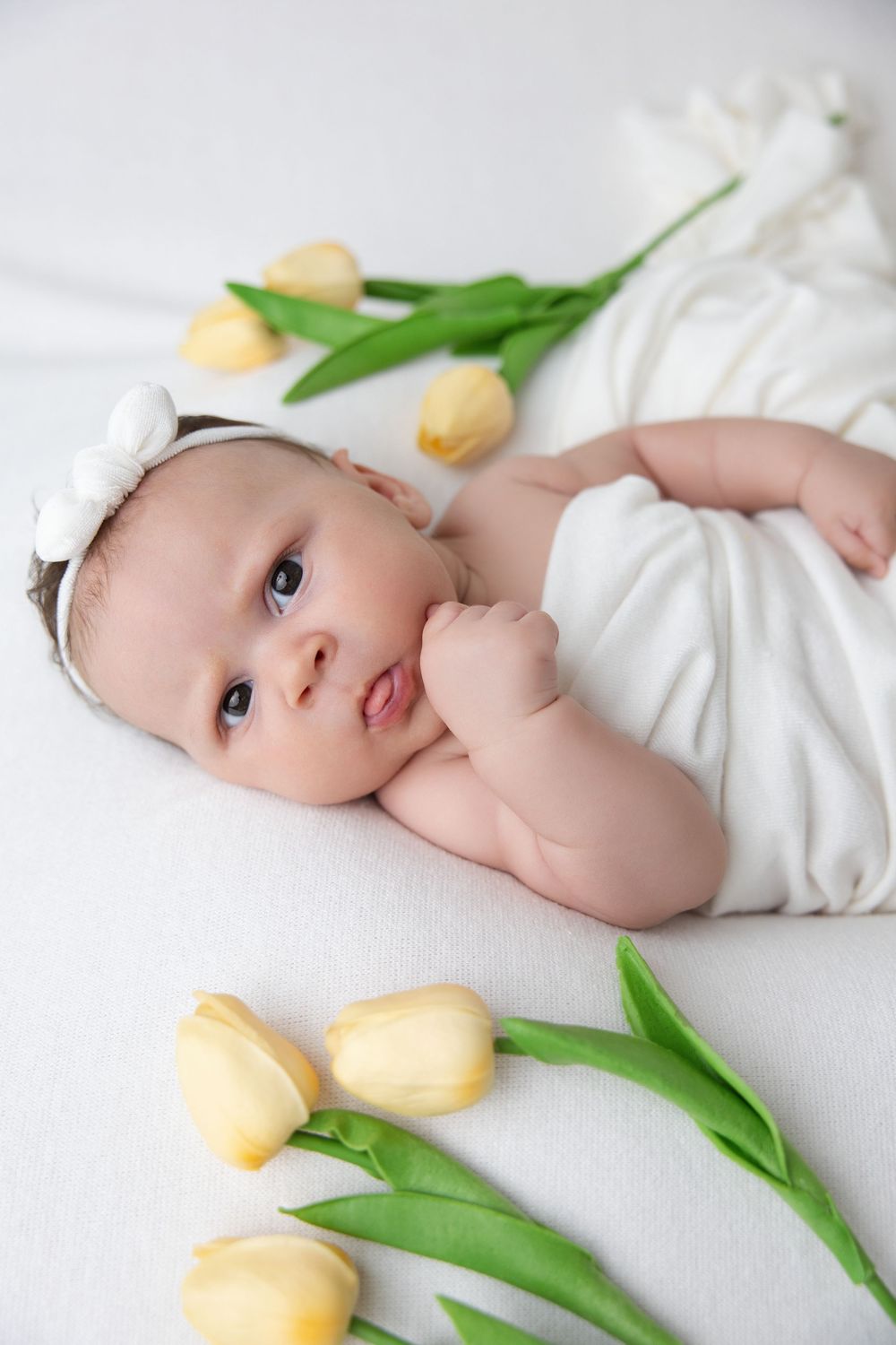 Six week old newborn girl white backdrop floral milestone portrait Nashville