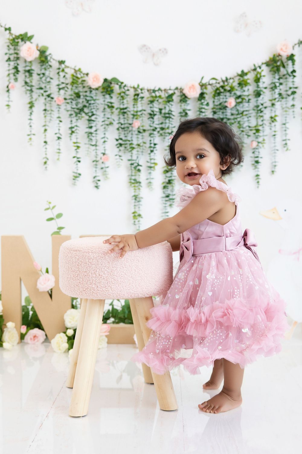 One year old girl pink dress floral themed birthday session Nashville