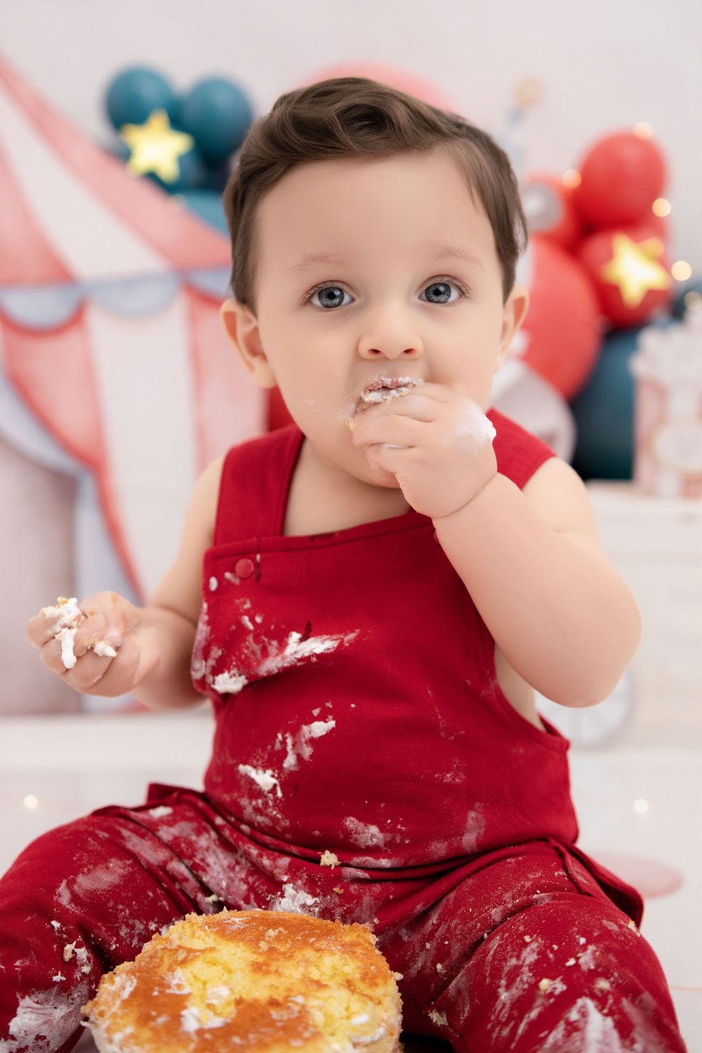 One year old boy eating cake first birthday smash session Nashville