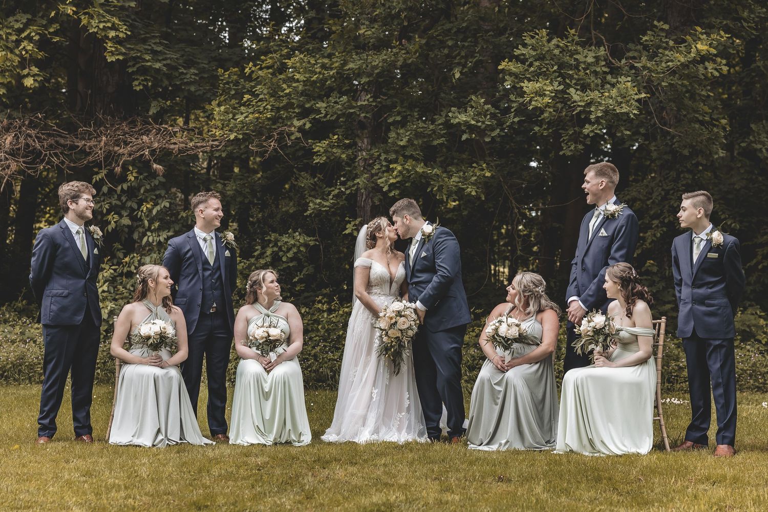 A traditional group photograph of newly weds with their bridesmaids and groomsmen