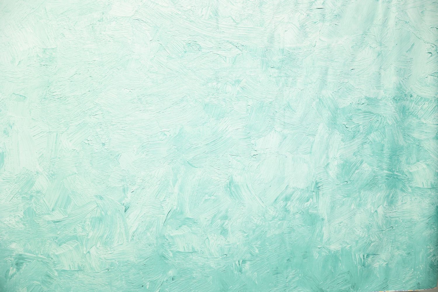 Light seafoam green painted wall texture with subtle variations and brushstrokes.