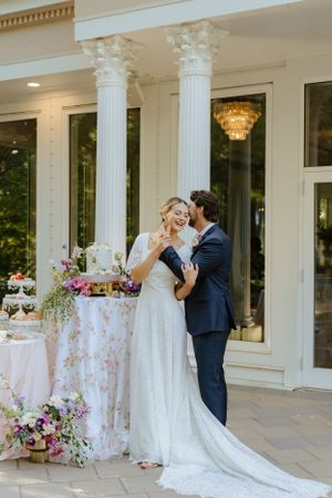 Wedding reception setup with classical columns and floral arrangements.