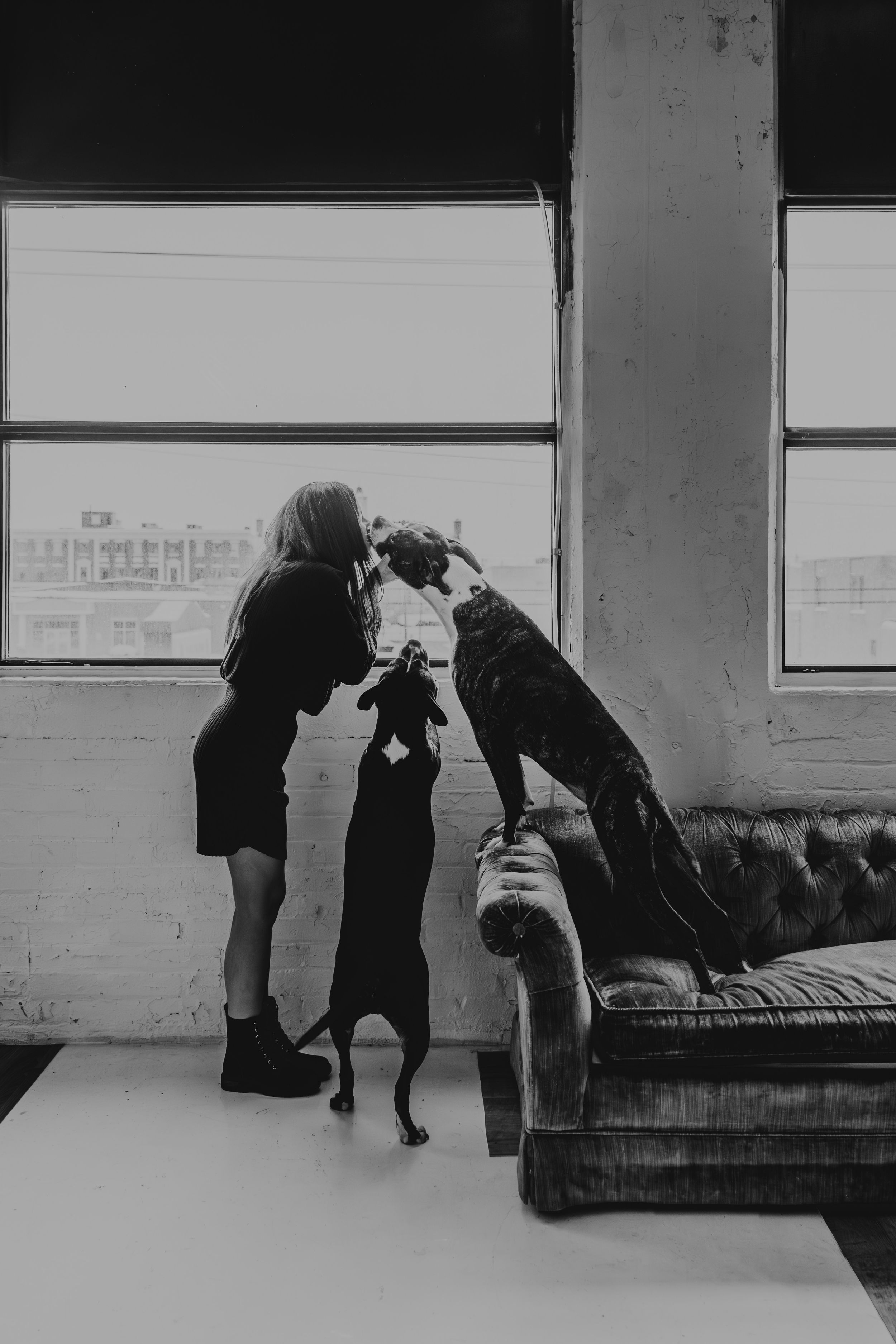 A black and white photo series showing a sequence of someone falling backwards onto a couch in five stages.