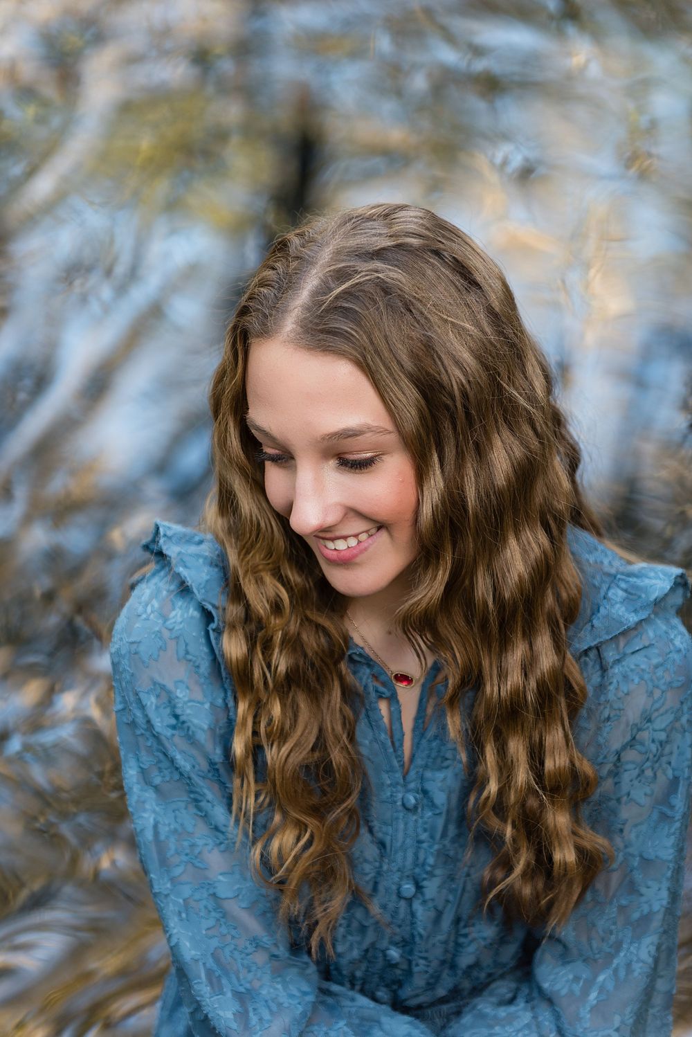 Senior girl smiling while looking away from camera