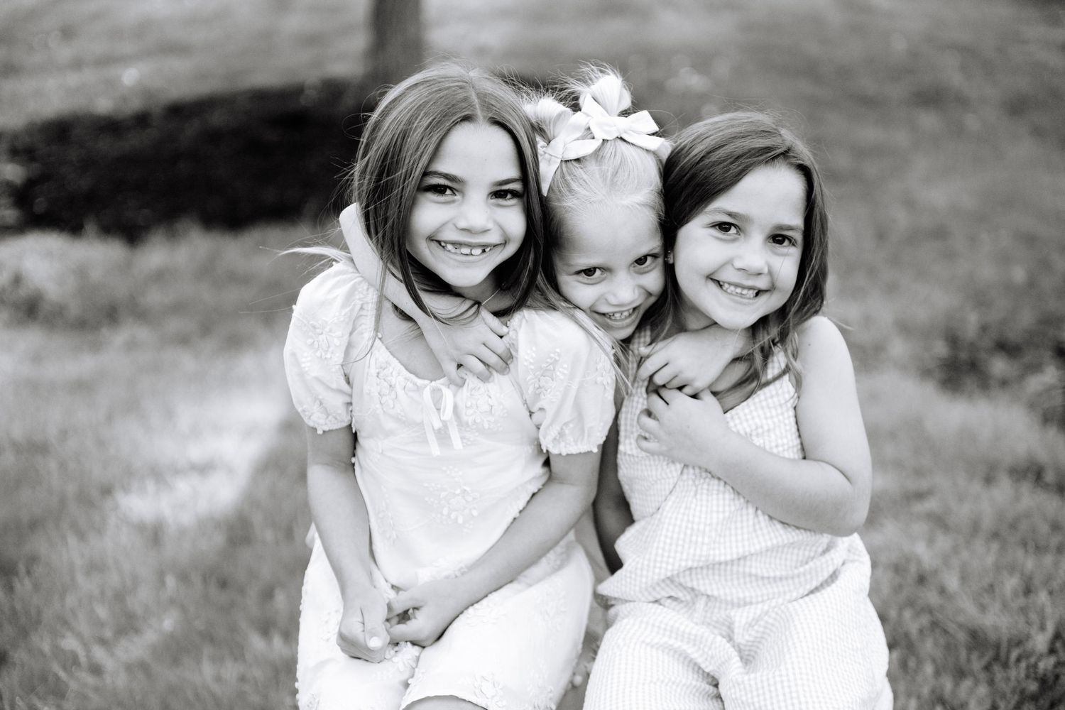 Casual outdoor portrait capturing tender family moments on a path.