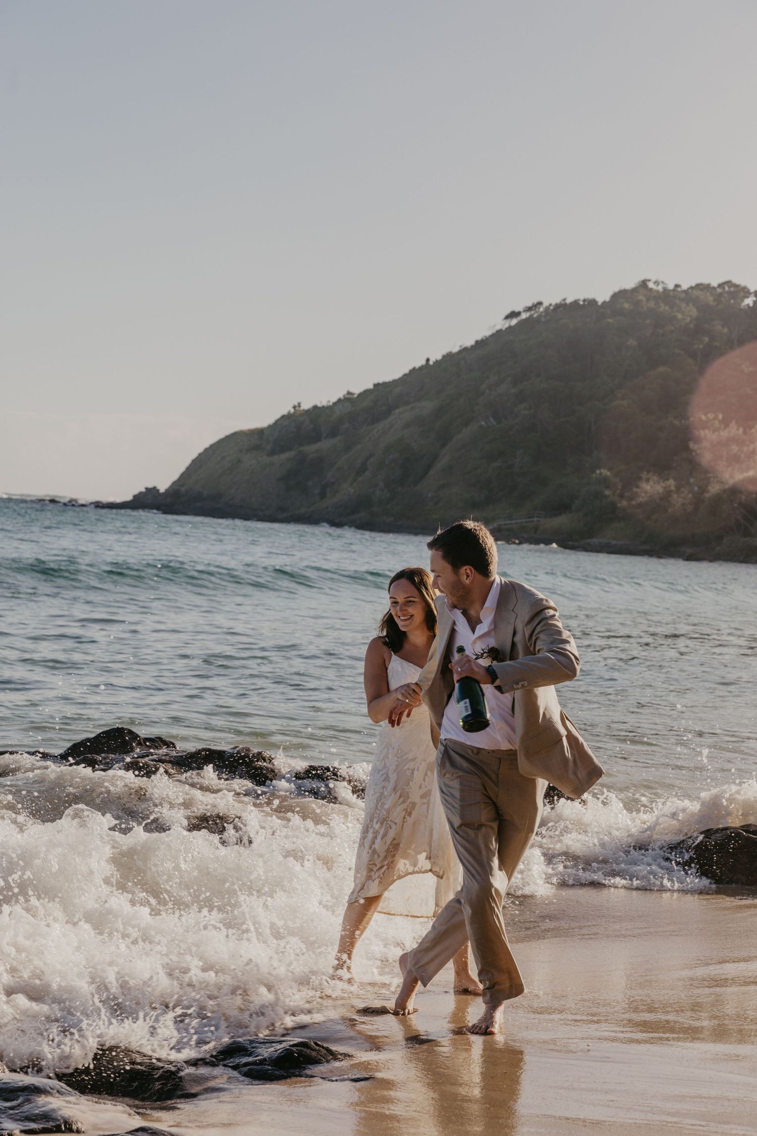Newly married couple in a vintage Volkswagen Kombi during their Byron Bay wedding, photographed by a Byron Bay wedding photographer.