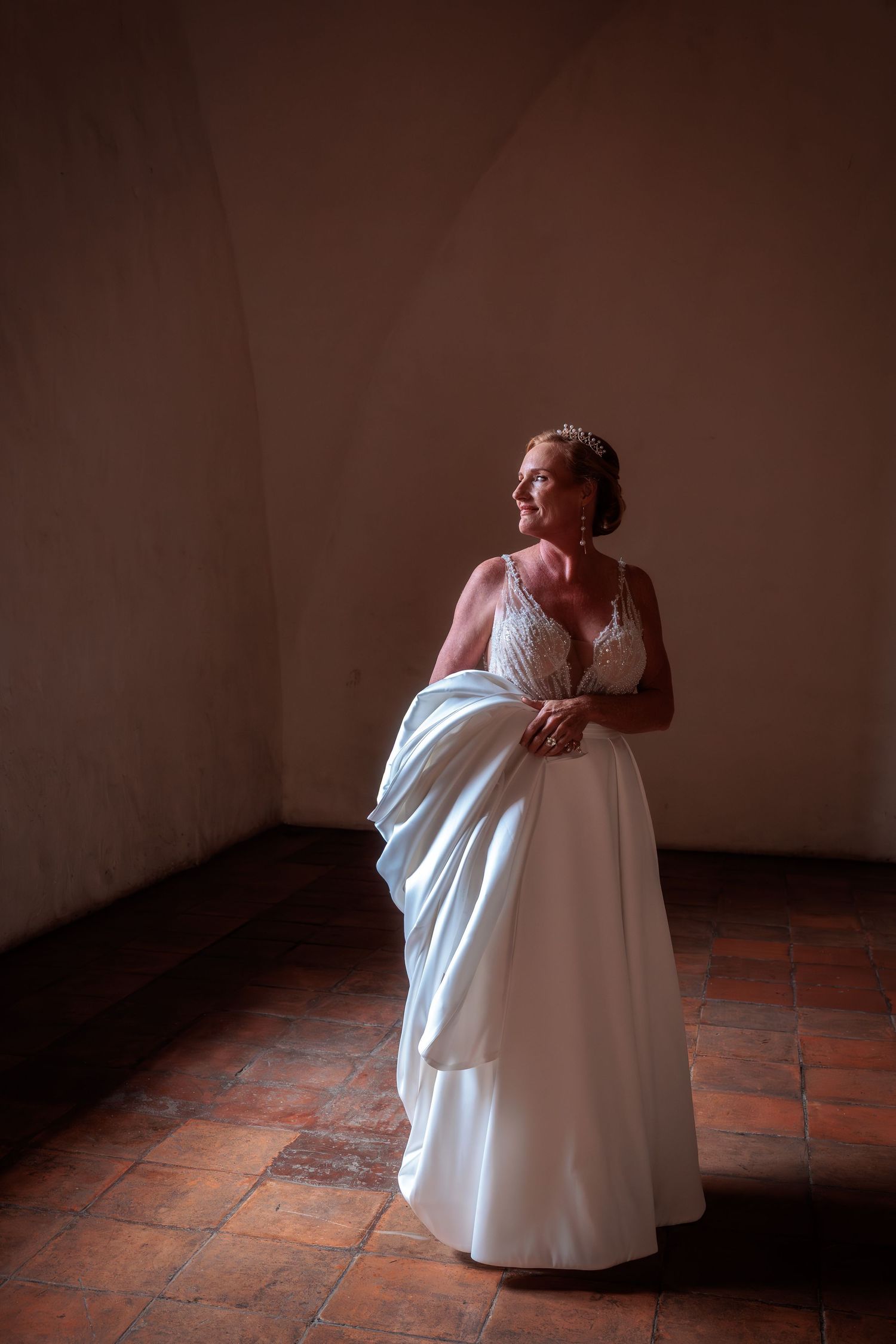 Wedding dress details captured in sequence against terracotta floor and walls.