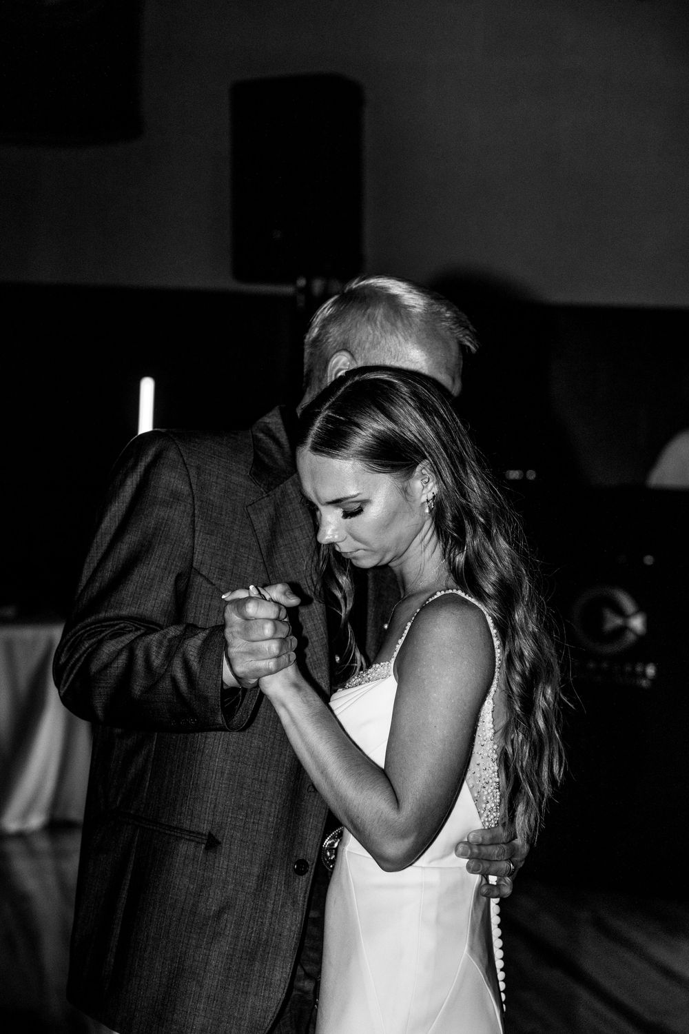 A romantic black and white photo sequence shows a couple sharing an intimate dance moment at a wedding reception.